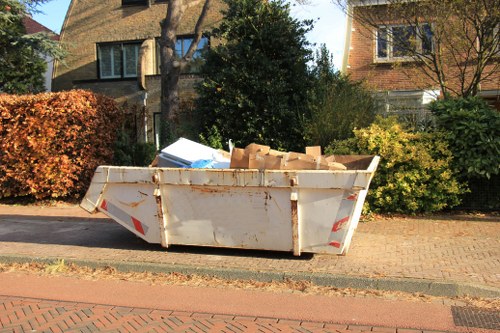 Large skip near a semi-detached house for garden clearance